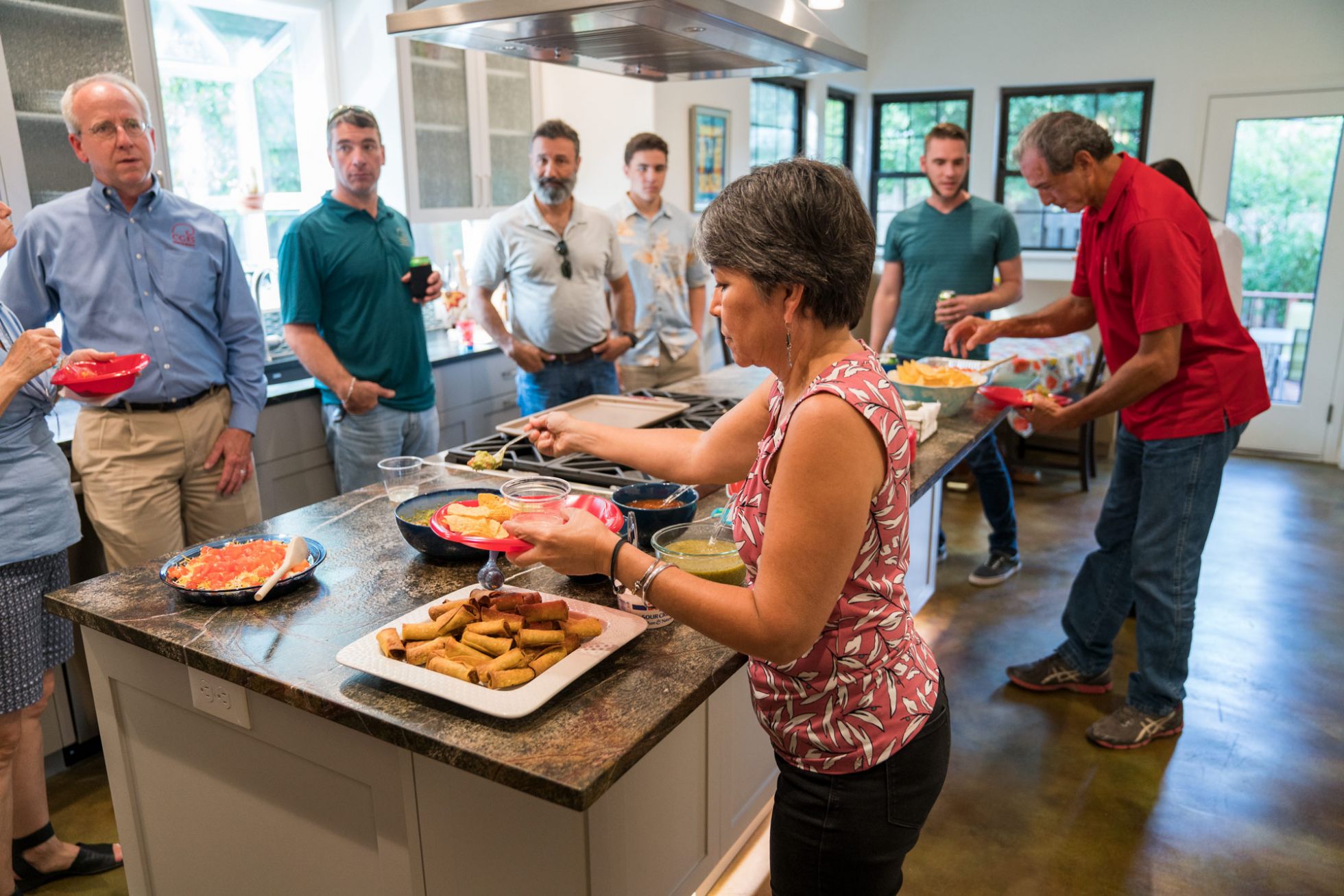 People gathered around kitchen island