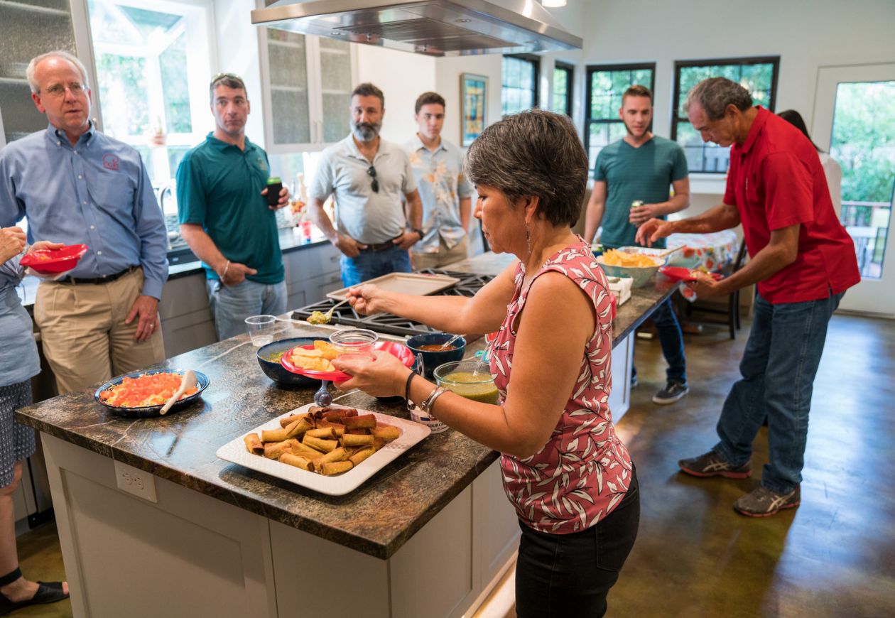 People gathered around kitchen island