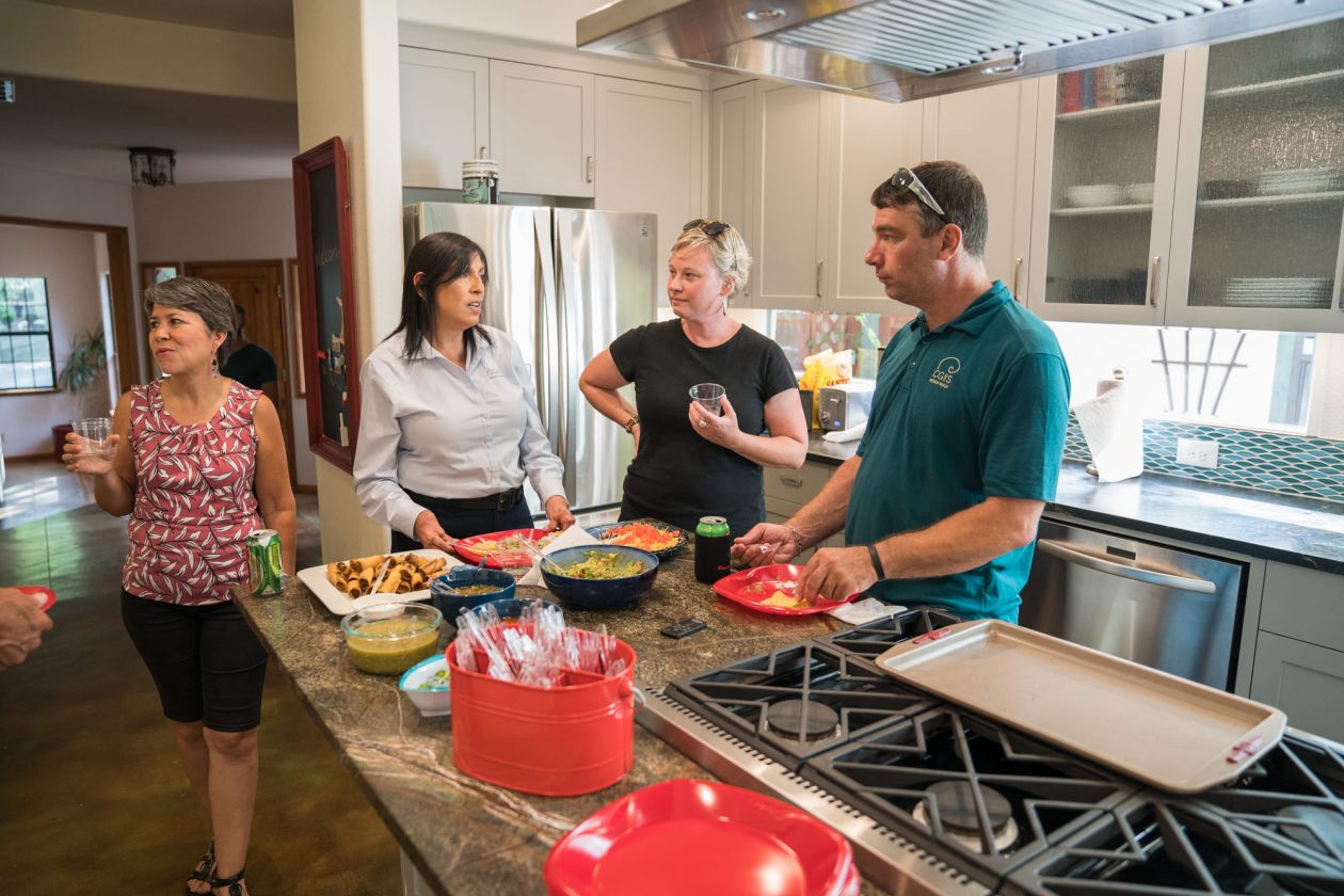 People Around Kitchen Island with Snacks