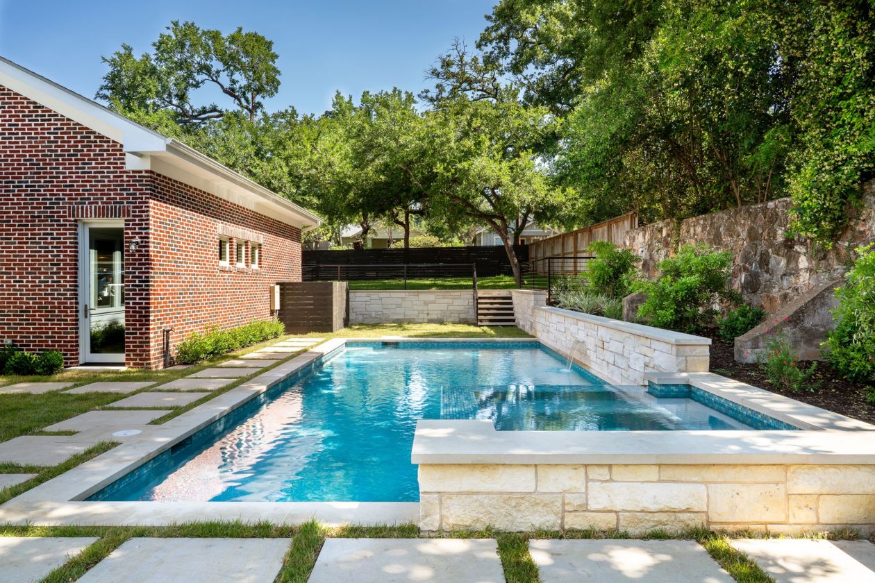 Large Backyard Residential Pool Surrounded by Trees